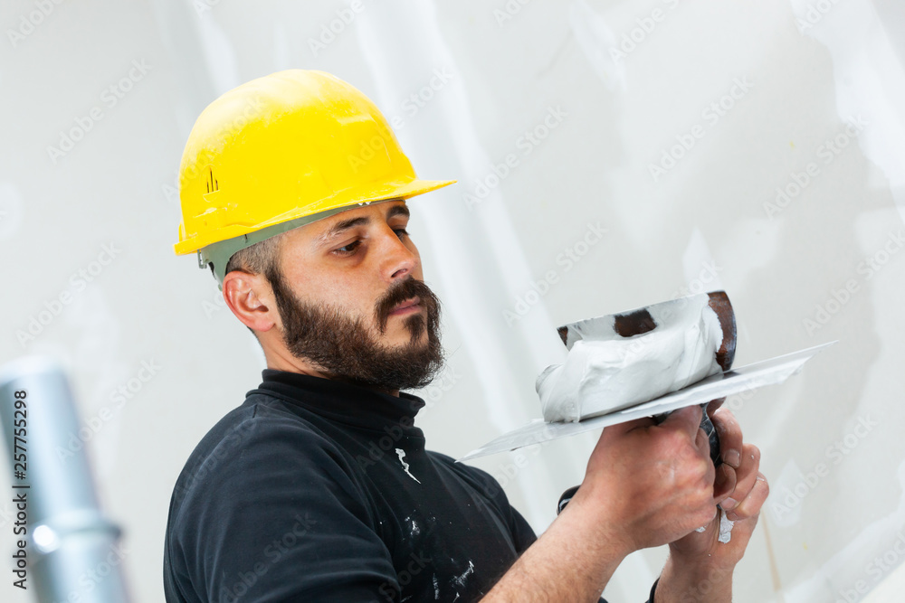 worker plastering gypsum board wall. worker plastering gypsum board wall.