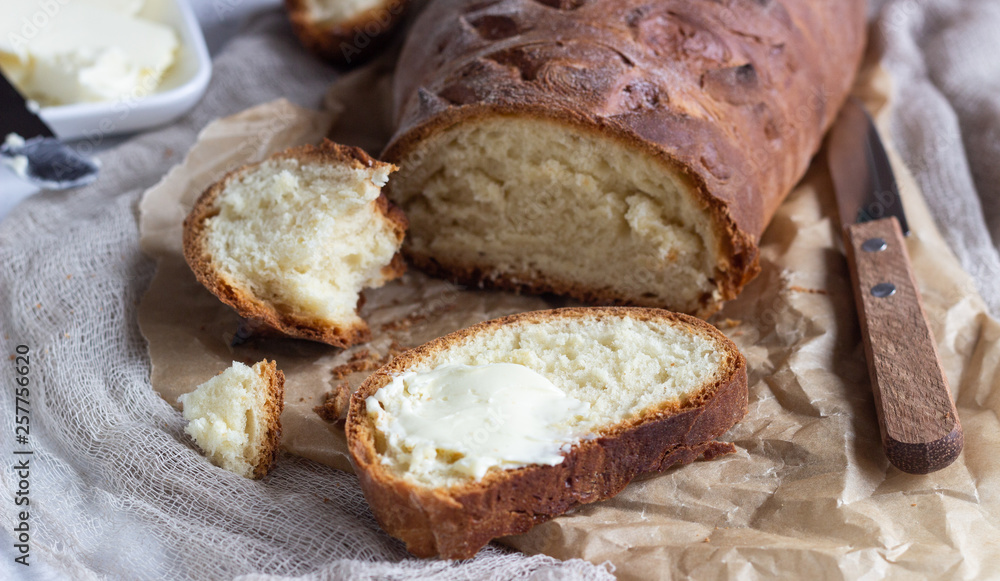 Butter and fresh bread. Simple breakfast on grey concrete background. Butter and fresh bread. Simple breakfast on grey concrete background.