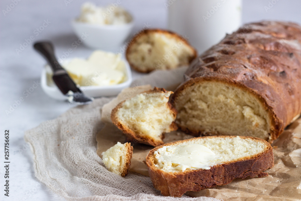 Butter and fresh bread. Simple breakfast on grey concrete background. Butter and fresh bread. Simple breakfast on grey concrete background.