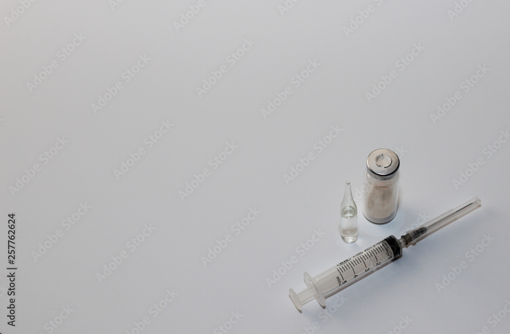 medical preparations in vials with a syringe on a white background medical preparations in vials with a syringe on a white background