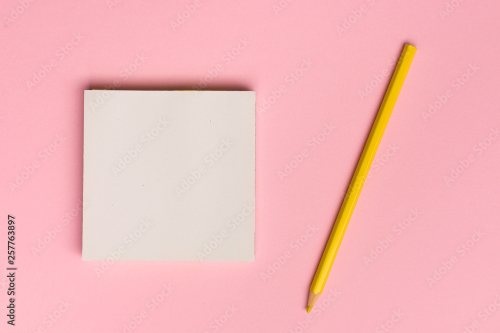 Top view flat lay picture with blank notepad page and pencil on colored surface Top view flat lay picture with blank notepad page and pencil on colored surface