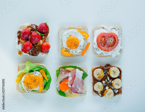 six sandwiches with tomatoes, omlette, chocolate, ham and cheese