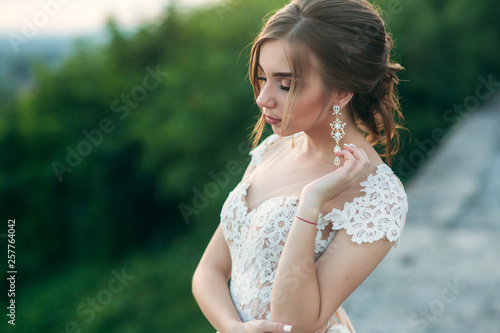 Elegant lady in white dress. Young model in evening dress
