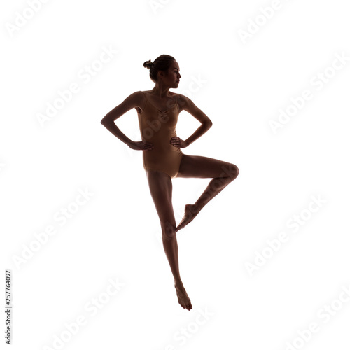 young beautiful dancer in beige swimsuit posing