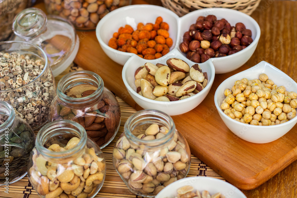 Various piles of mixed nuts and seeds Various piles of mixed nuts and seeds
