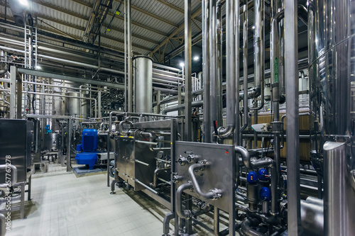 Industrial stainless steel vats in modern brewery 
