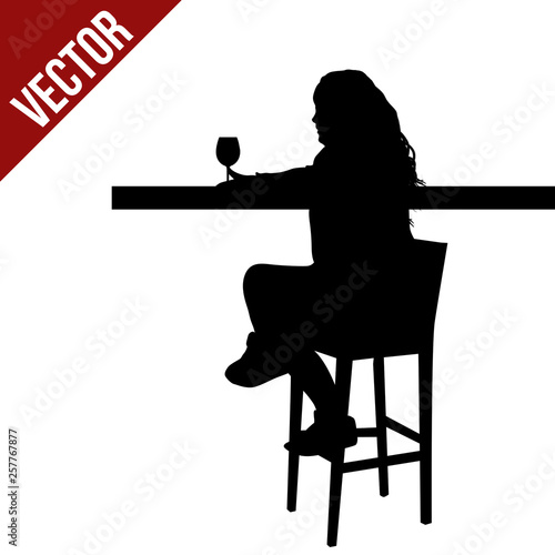 Woman silhouette sitting at a table in the cafe, bar, restaurant or pub