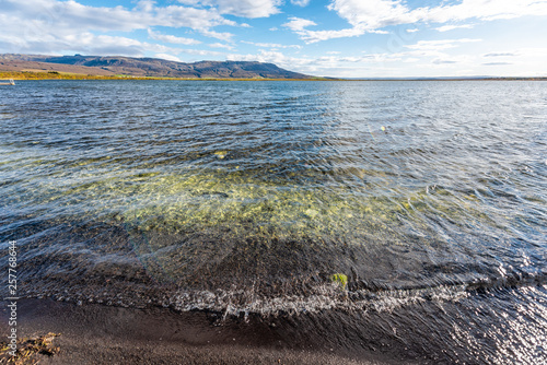 Laugarvatn lake in south Iceland on Golden Circle shore water closeup wide angle view of Hot Springs Geothermal area on sunny day photo