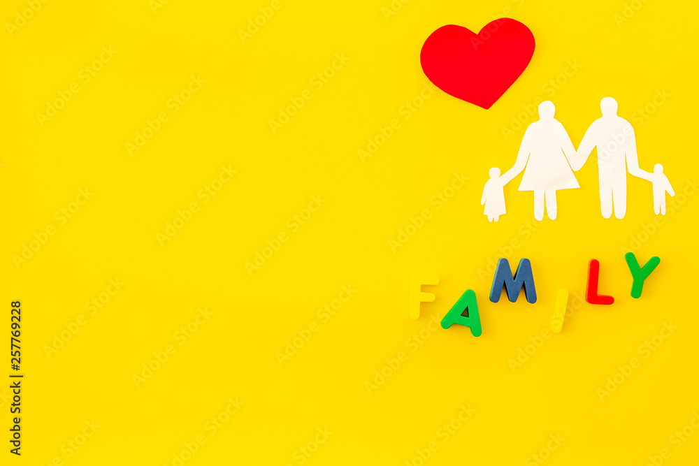 family word and figure for adopt child concept on yellow background top view mock up family word and figure for adopt child concept on yellow background top view mock up