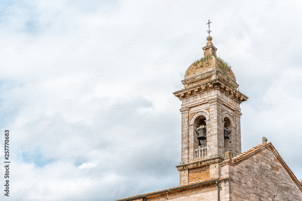 San Quirico D'Orcia, Italy small historic medieval town village in Tuscany and famous church bell tower closeup isolated against sky