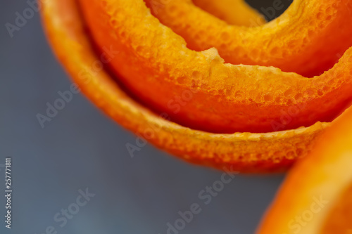 Macro citrus fruit peel. Background with peel a tangerine. Art image with a peel mandarin. Closeup and texture with a peel an orange. A concept for a decor food. Top view. Soft focus. Copy space.