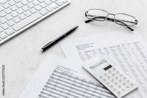 business accounter work with taxes calculation and keyboard on white office desk background photo