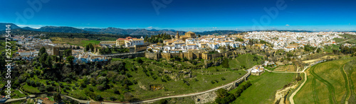 Ronda Spain aerial view of medieval hilltop town surrounded by walls and towers with famous bridge over gorge © tamas