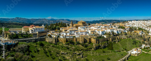 Ronda Spain aerial view of medieval hilltop town surrounded by walls and towers with famous bridge over gorge