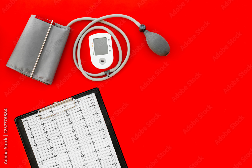 cardiologist work desk with pulsimeter and cardiogram on red background top view copyspace cardiologist work desk with pulsimeter and cardiogram on red background top view copyspace