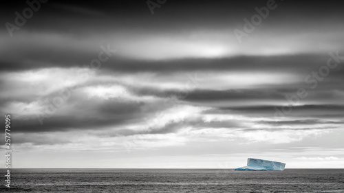 Photos Solitary iceberg in the Southern Ocean under stormy dramatic sky