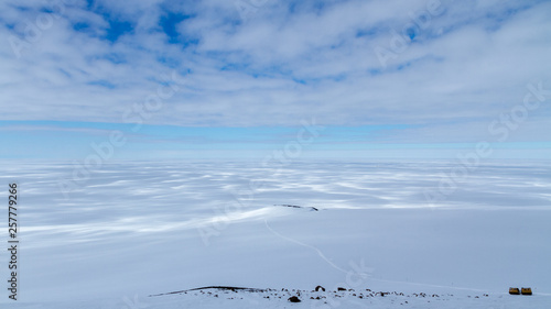 A Haaglunds or over-snow vehicle on the Ross Ice Shelf with expansive view of Antarctica © James Stone