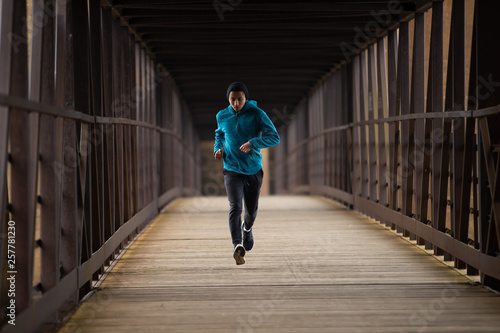 Hispanic Teenager Running By Himself On On A Bridge