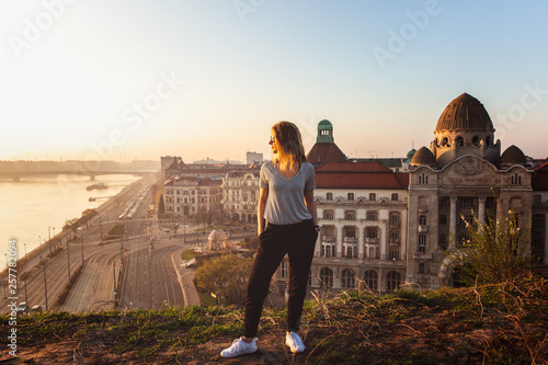 Photography Beautiful woman standing opposite famous facade and entrance to Hotel Gellert on