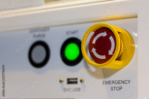 Close up emergency stop button on control panel of machine for safety at factory photo