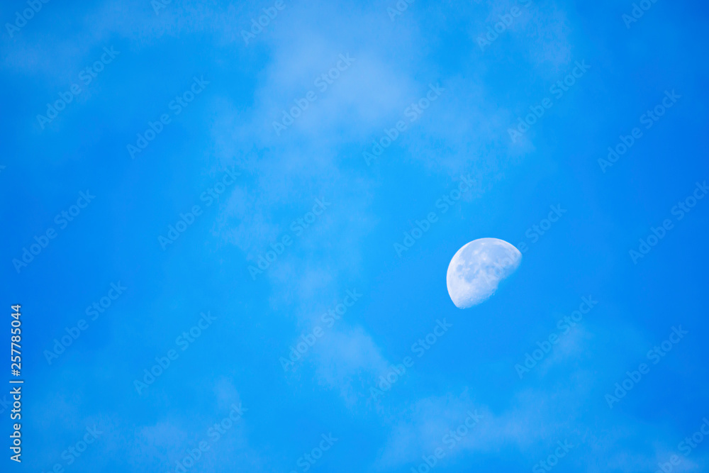 Full moon in daylight On the bright sky.