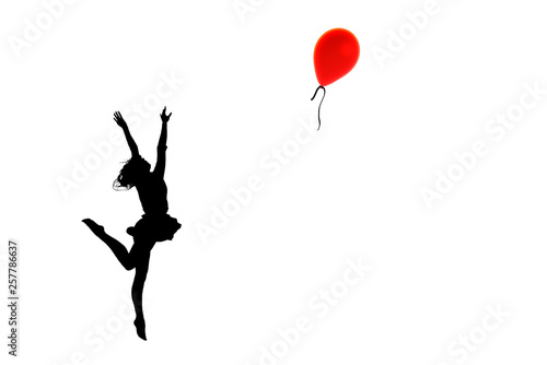 Silhouette of a girl  in the pose of a jumping ballerina behind a red balloon  with outstretched arms in the form of wings.