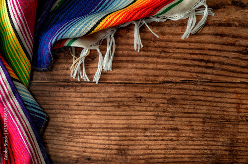 Obraz na płótnie Cinco de mayo fiesta party and indigenous cultures of Mexico concept theme with a Mexican rug called a serape isolated on wood background with copy space w salonie