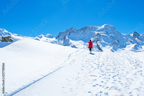 Young woman tourist walking in the snow, Zermatt, Switzerland. © sahachat