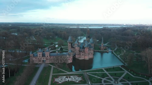 Aerial shot of medieval castle, modern city in background photo