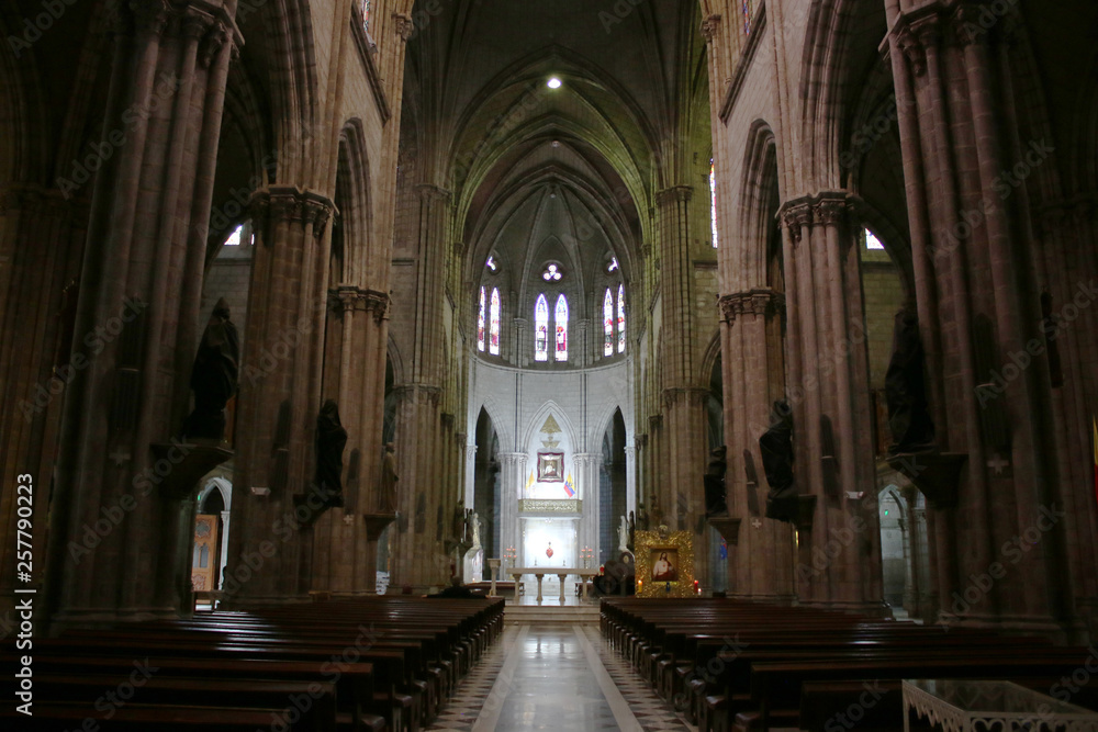 View from the entrance of the interior of a large neo gothic catolic church in Quito Ecuador