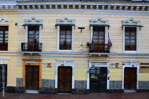 Colorfol row of windows and doors with flags on a steep hill in quito ecuador