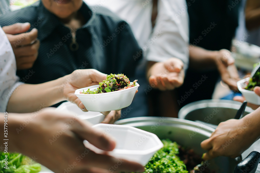 Volunteers serving charity food to the poor: the concept of hunger Volunteers serving charity food to the poor: the concept of hunger