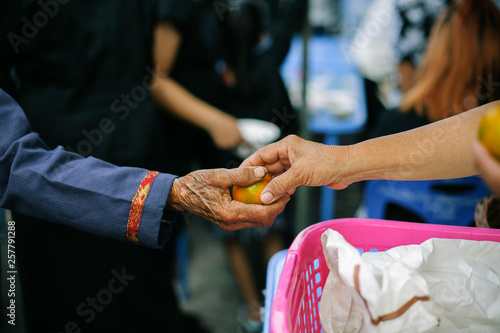 Food donation: The hands of the hungry are receiving food from the service provider.