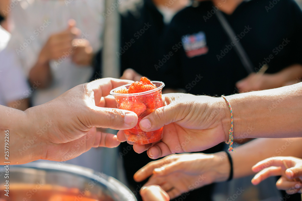Charity food : Feeding the poor to hands of a beggar. Poverty concept Charity food : Feeding the poor to hands of a beggar. Poverty concept