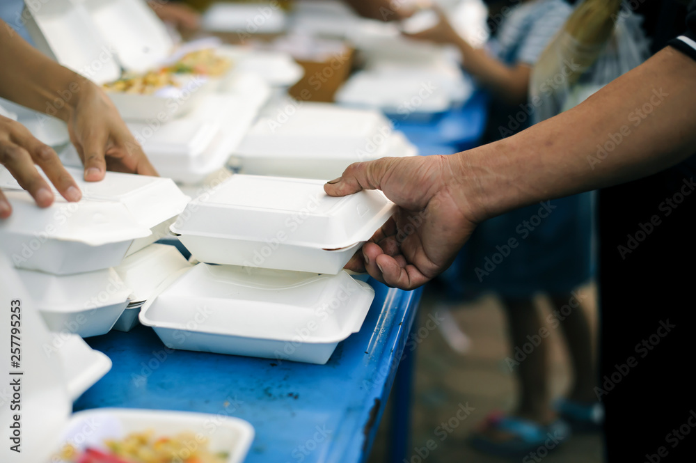 Fototapeta premium hands of the poor receive food from the donor's share. poverty concept