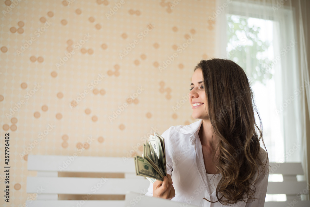 Woman with dollar bank note on the bed Woman with dollar bank note on the bed