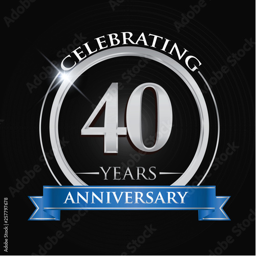 Celebrating 40 years anniversary logo. with silver ring and blue ribbon.