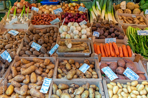 Different kinds of potatoes and other vegetables for sale at a market