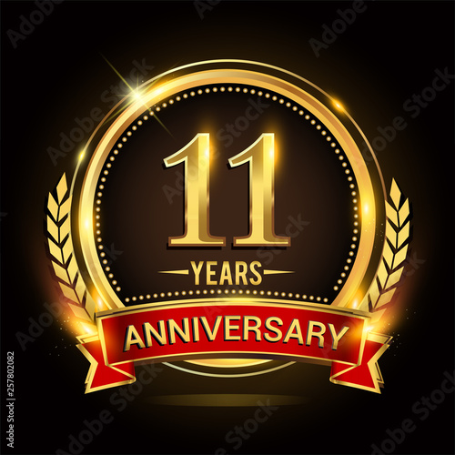 Celebrating 11th years anniversary logo with golden ring and red ribbon.