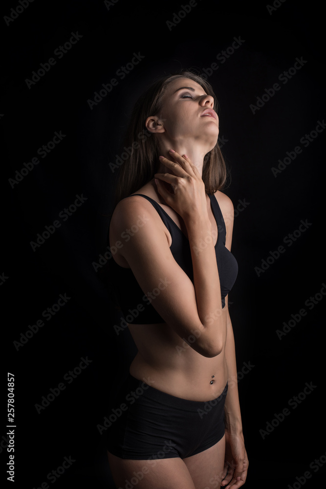 Beautiful woman with healthy body on black background