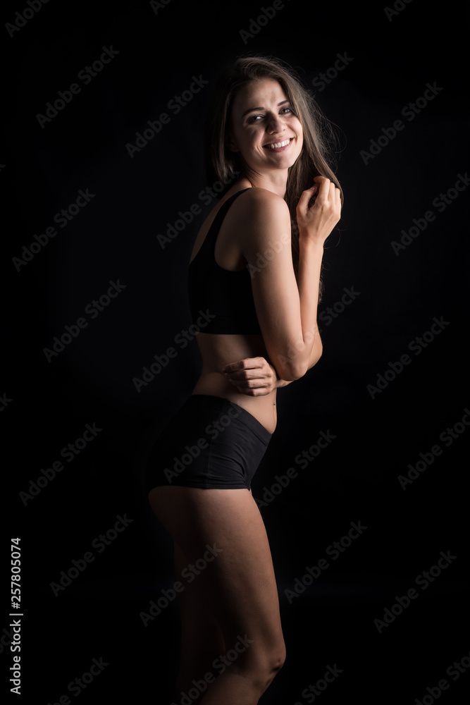Beautiful woman with healthy body on black background Beautiful woman with healthy body on black background