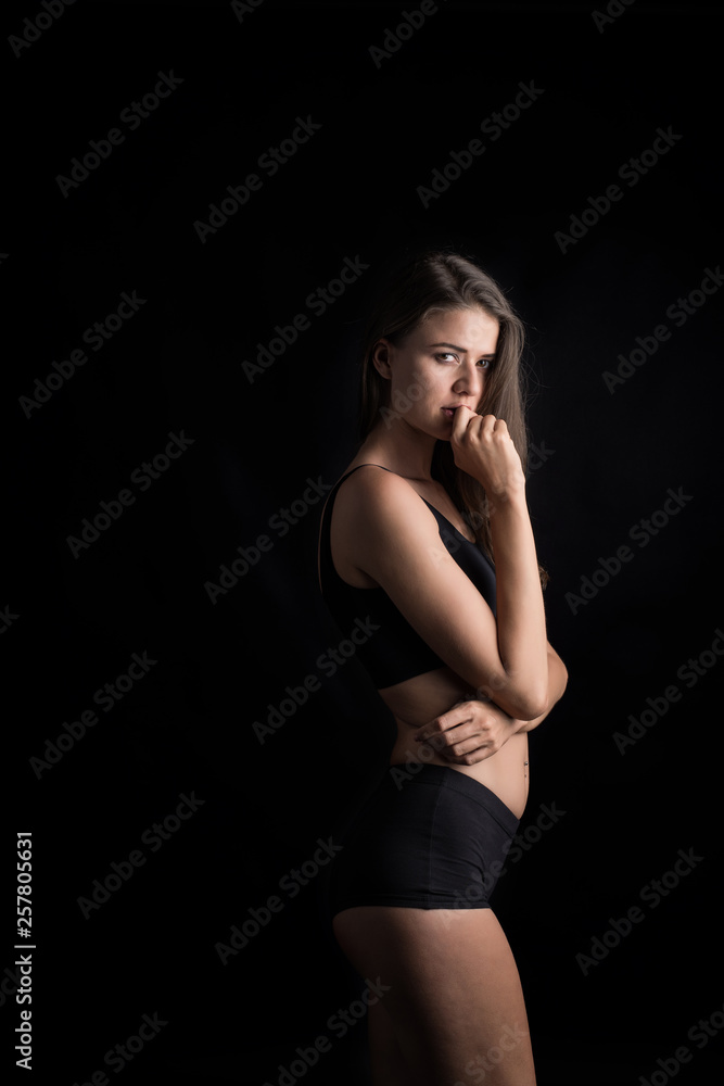 Beautiful woman with healthy body on black background Beautiful woman with healthy body on black background