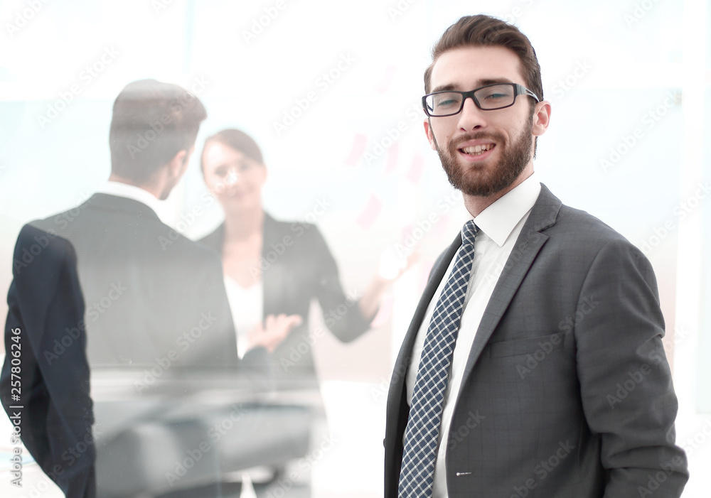 confident businessman in the background of the office confident businessman in the background of the office