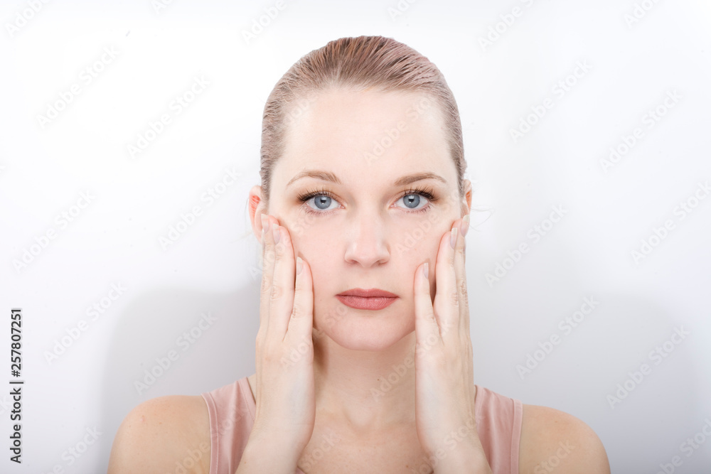 facial gymnastics. the girl does massage and rejuvenating exercises for the face facial gymnastics. the girl does massage and rejuvenating exercises for the face