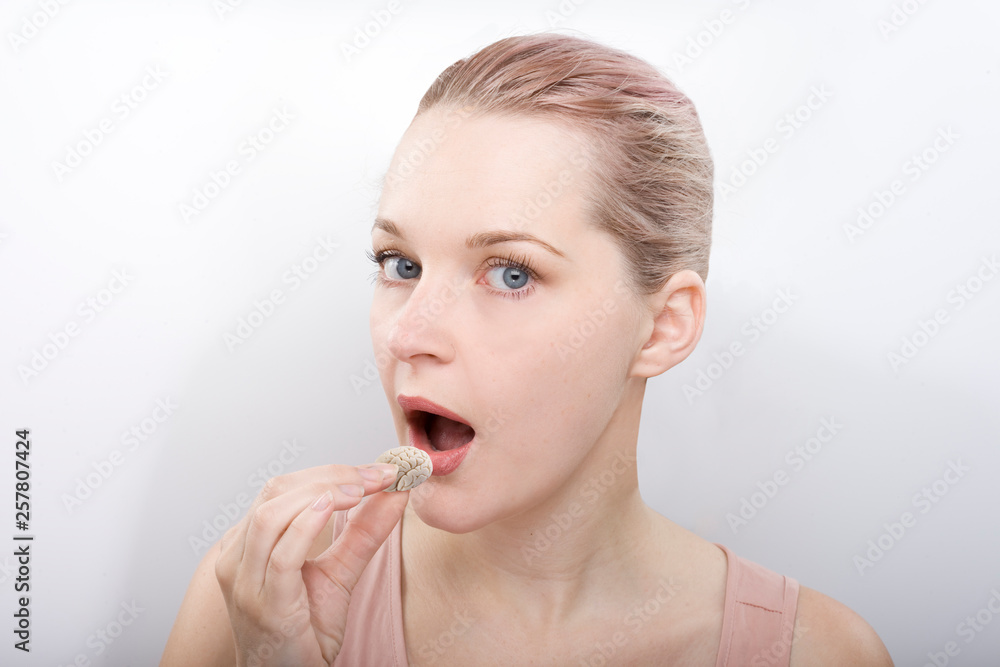the development of intelligence. Plays logic, brain development and the nervous system. Girl is going to eat the tablet in the form of the brain. to pump of the brain the development of intelligence. Plays logic, brain development and the nervous system. Girl is going to eat the tablet in the form of the brain. to pump of the brain