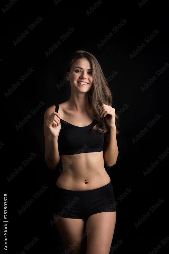 Beautiful woman with healthy body on black background Beautiful woman with healthy body on black background
