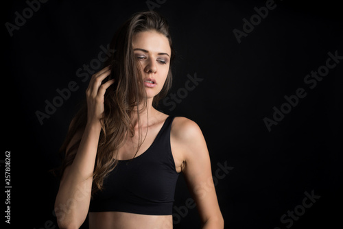 Beautiful woman with healthy body on black background