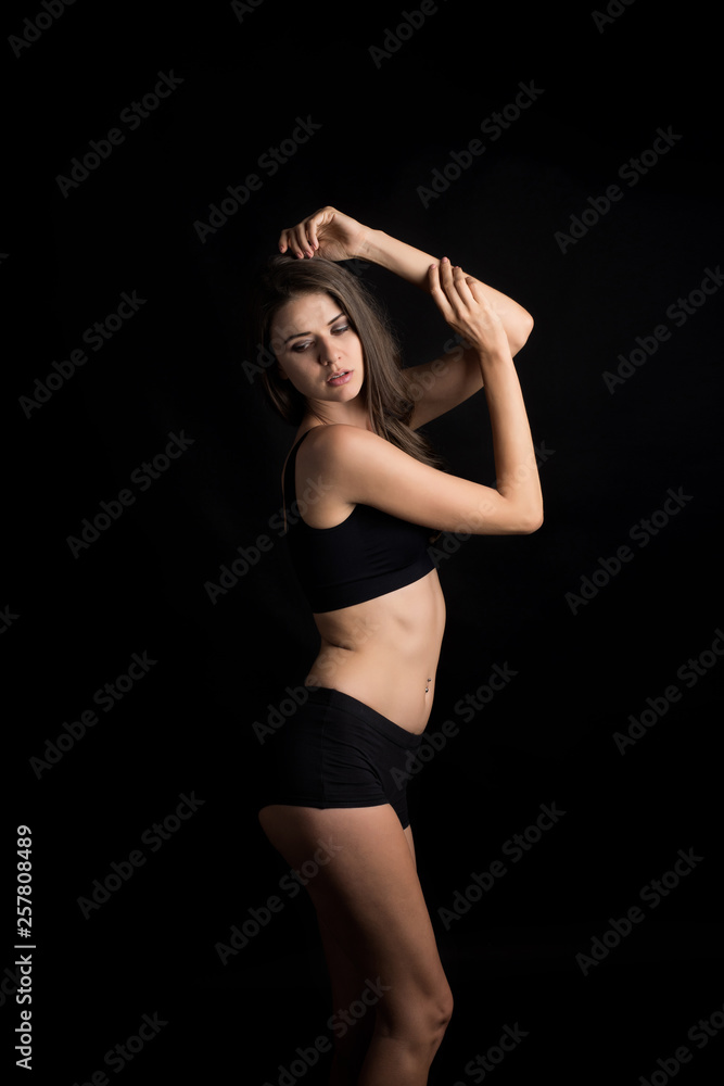 Beautiful woman with healthy body on black background Beautiful woman with healthy body on black background