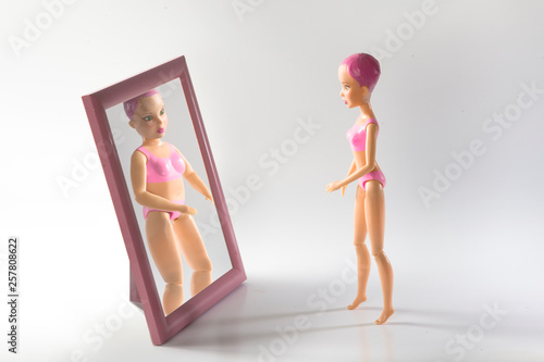 doll with food addiction trying to induce vomiting. Signs, consequences, symptoms and treatment of anorexia. the girl sick Problems with weight, food addiction in women, bulimia and anorexia photo
