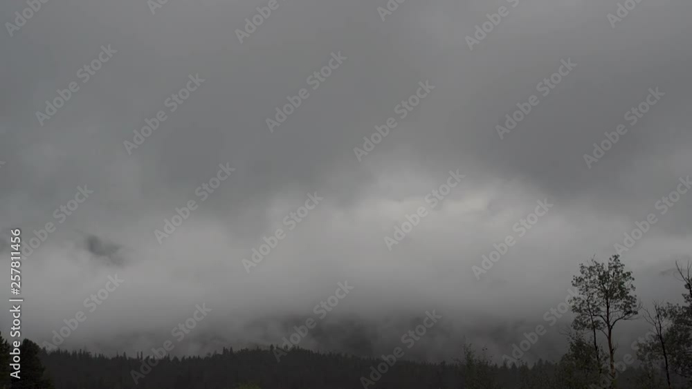 time lapse of storm clouds and fog rolling through mountains time lapse of storm clouds and fog rolling through mountains